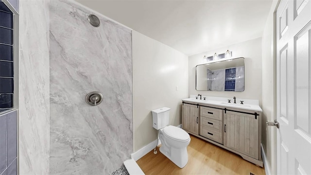 1005 45th St W, Bradenton, FL 34209 - bathroom with a marble finish shower, wood finished floors, and double vanity
