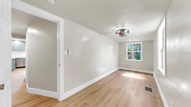 1005 45th St W, Bradenton, FL 34209 - unfurnished room featuring light wood-style flooring and a textured ceiling
