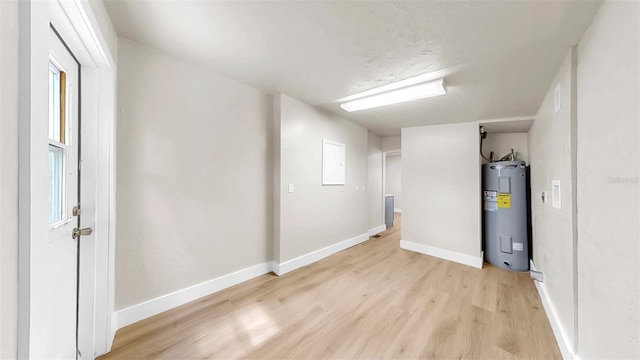 1005 45th St W, Bradenton, FL 34209 - basement with electric water heater and light wood-style flooring