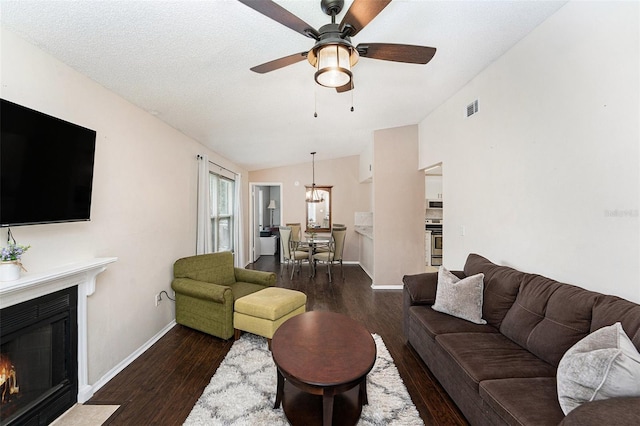 4014 Dream Oak Pl Unit 202, Tampa, FL 33613 - living area featuring vaulted ceiling, a ceiling fan, a fireplace with flush hearth, and dark wood-style floors