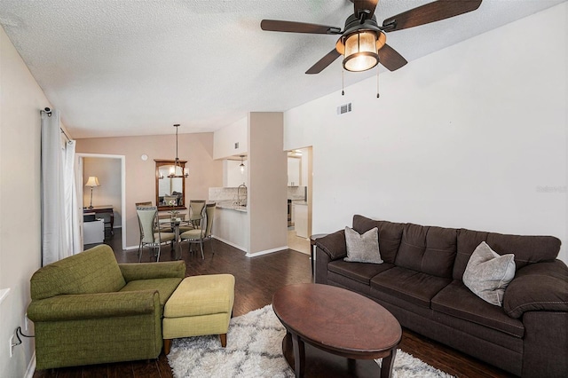 4014 Dream Oak Pl Unit 202, Tampa, FL 33613 - living room featuring dark wood-style flooring, ceiling fan, vaulted ceiling, and a chandelier