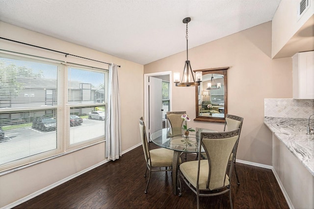 4014 Dream Oak Pl Unit 202, Tampa, FL 33613 - dining area featuring dark wood-style floors, lofted ceiling, and a chandelier