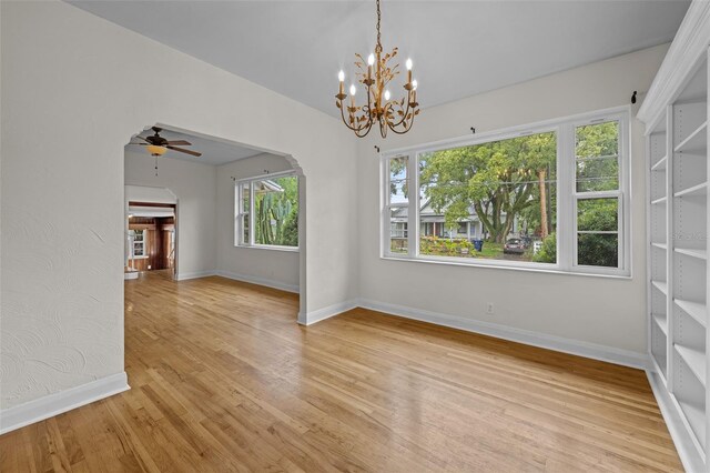 2819 N Central Ave, Tampa, FL 33602 - unfurnished room featuring light wood-type flooring, a chandelier, and ceiling fan