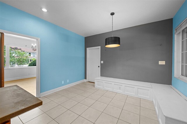 2819 N Central Ave, Tampa, FL 33602 - unfurnished dining area featuring tile patterned floors and a chandelier