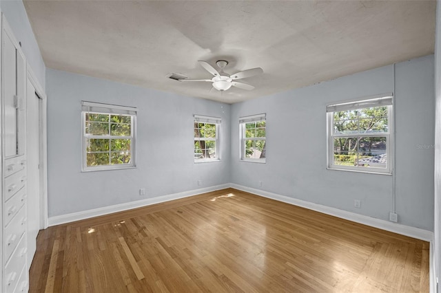 2819 N Central Ave, Tampa, FL 33602 - unfurnished bedroom featuring light wood-style floors, a ceiling fan, and a closet