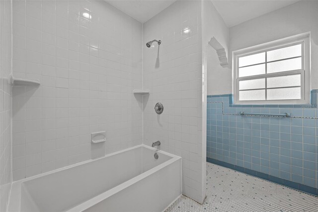 2819 N Central Ave, Tampa, FL 33602 - bathroom with tile walls, washtub / shower combination, wainscoting, and tile patterned flooring