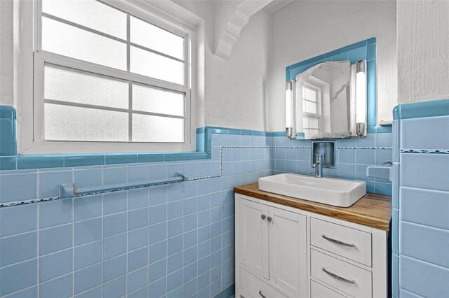 2819 N Central Ave, Tampa, FL 33602 - bathroom featuring vanity, wainscoting, and tile walls