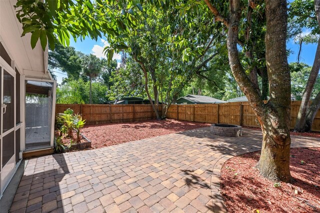 2819 N Central Ave, Tampa, FL 33602 - fenced backyard with a fire pit and a patio area