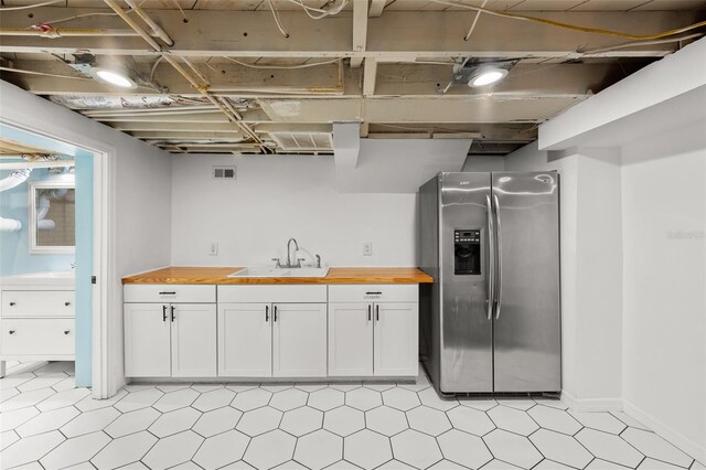 2819 N Central Ave, Tampa, FL 33602 - kitchen featuring stainless steel fridge with ice dispenser, wood counters, and white cabinetry