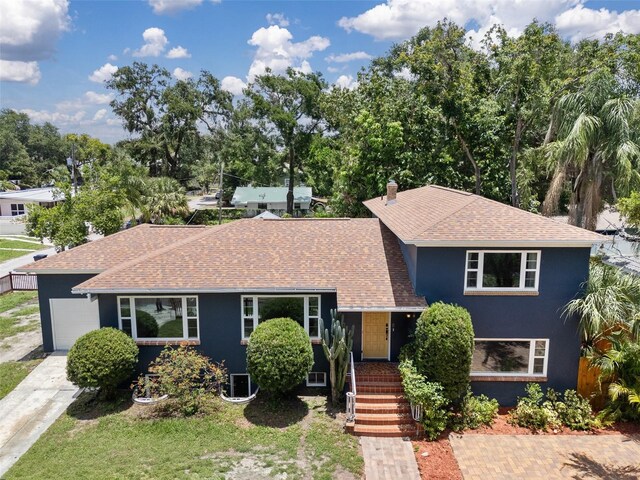 2819 N Central Ave, Tampa, FL 33602 - view of front of property featuring a shingled roof and stucco siding