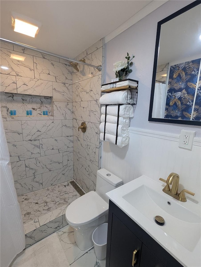 1028 E 93rd Ave Unit A, Tampa, FL 33612 - bathroom with vanity, tiled shower, marble finish flooring, and a wainscoted wall