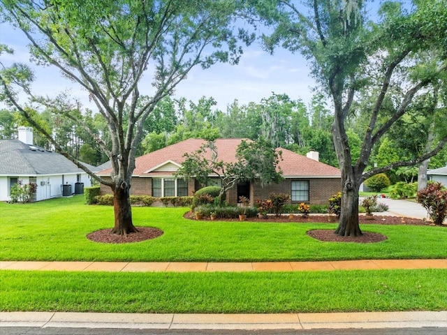 1015 Hastings Ct, Lutz, FL 33548 - single story home with a front yard, brick siding, and a chimney