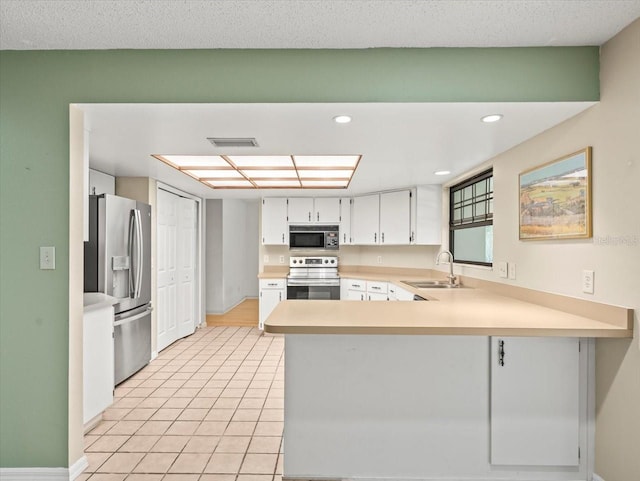 1015 Hastings Ct, Lutz, FL 33548 - kitchen with stainless steel appliances, a peninsula, light countertops, light tile patterned floors, and white cabinets