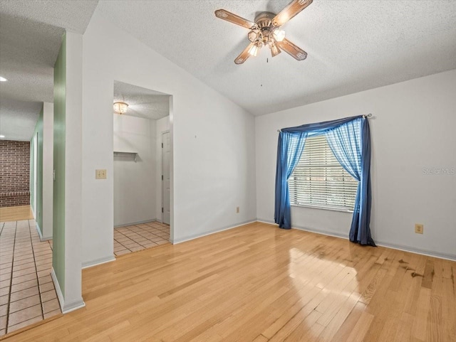 1015 Hastings Ct, Lutz, FL 33548 - unfurnished room with a textured ceiling, light wood finished floors, vaulted ceiling, and ceiling fan