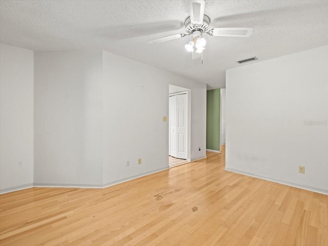 1015 Hastings Ct, Lutz, FL 33548 - spare room with wood finished floors, a textured ceiling, and ceiling fan