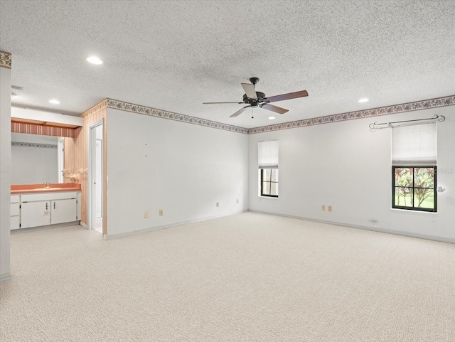 1015 Hastings Ct, Lutz, FL 33548 - carpeted spare room featuring a textured ceiling, a ceiling fan, and recessed lighting