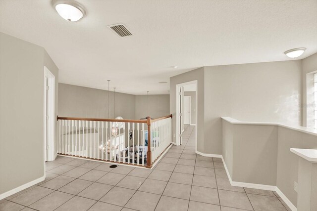 6439 Gentle Ben Cir, Wesley Chapel, FL 33544 - corridor featuring an upstairs landing and tile patterned floors