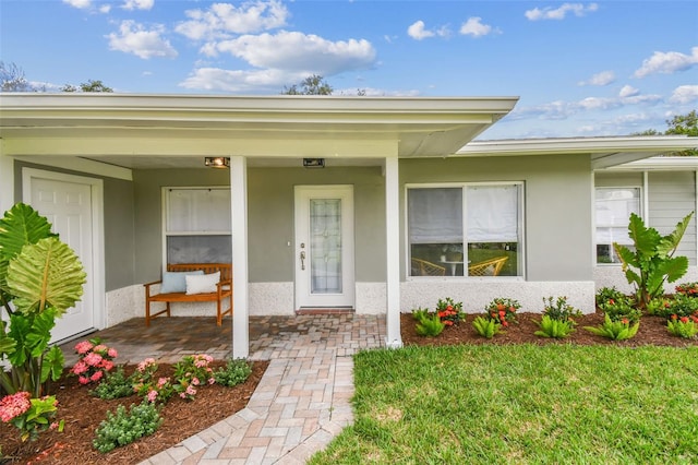 2452 Bayshore Blvd, Dunedin, FL 34698 - entrance to property featuring stucco siding and covered porch