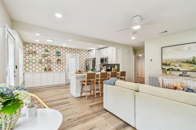 2452 Bayshore Blvd, Dunedin, FL 34698 - living area featuring light wood-style floors, a ceiling fan, recessed lighting, and wallpapered walls
