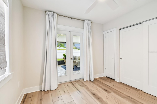2452 Bayshore Blvd, Dunedin, FL 34698 - unfurnished bedroom featuring light wood-type flooring, french doors, access to exterior, and a ceiling fan