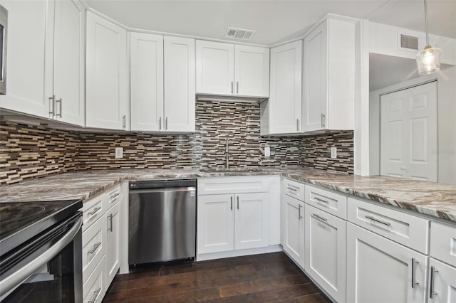 345 S Mcmullen Booth Rd Unit 142, Clearwater, FL 33759 - kitchen featuring appliances with stainless steel finishes, white cabinets, and light stone counters
