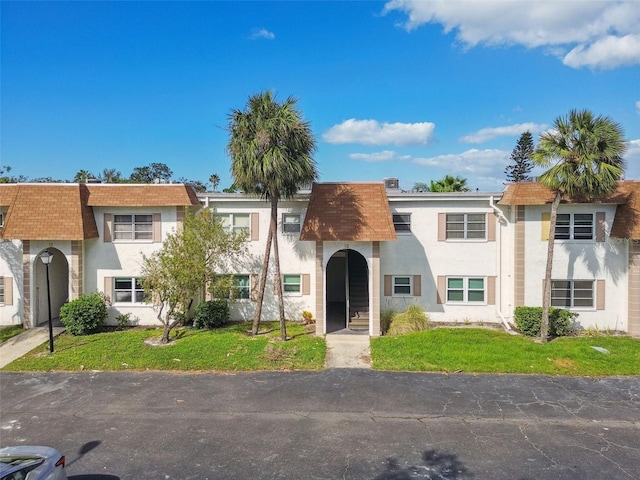 345 S Mcmullen Booth Rd Unit 142, Clearwater, FL 33759 - townhome / multi-family property featuring mansard roof, stucco siding, and roof with shingles