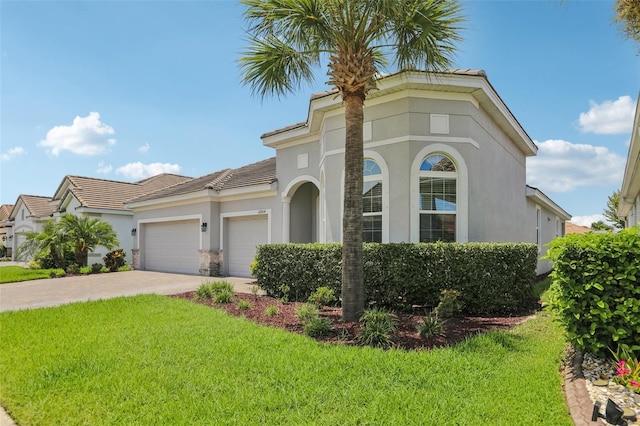 12004 Cinnamon Fern Dr, Riverview, FL 33579 - mediterranean / spanish-style house with a garage, a front lawn, driveway, and stucco siding