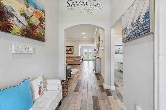 12004 Cinnamon Fern Dr, Riverview, FL 33579 - corridor with arched walkways, wood finished floors, and french doors