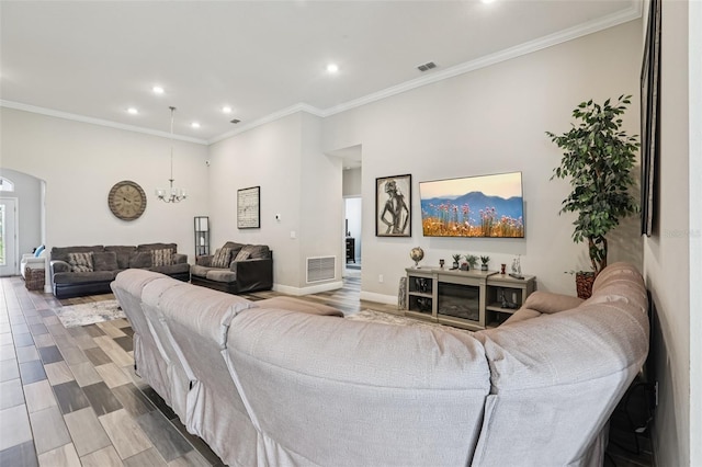 12004 Cinnamon Fern Dr, Riverview, FL 33579 - living room with arched walkways, a chandelier, recessed lighting, crown molding, and wood finished floors