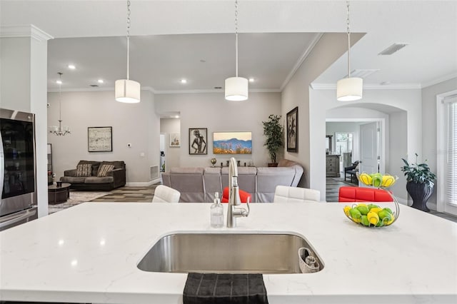 12004 Cinnamon Fern Dr, Riverview, FL 33579 - kitchen featuring open floor plan, light stone countertops, hanging light fixtures, recessed lighting, and an island with sink