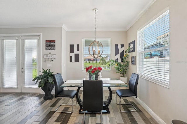 12004 Cinnamon Fern Dr, Riverview, FL 33579 - dining space featuring wood finished floors, a chandelier, and crown molding