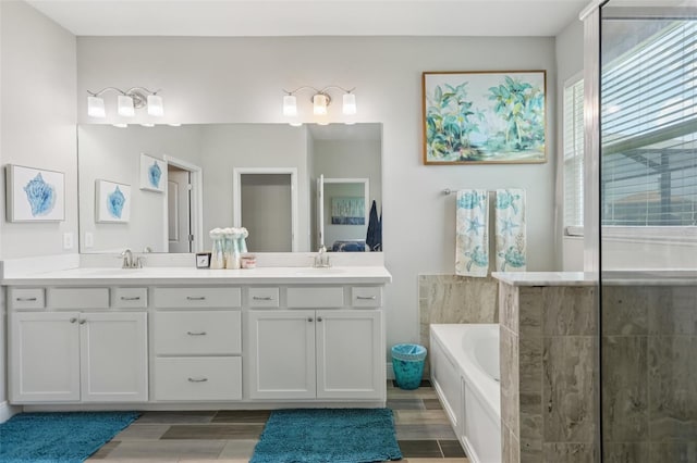 12004 Cinnamon Fern Dr, Riverview, FL 33579 - bathroom featuring double vanity, a bath, wood finished floors, and a shower