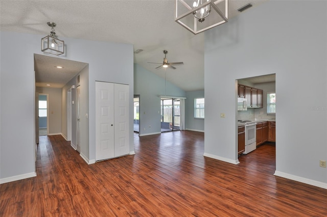 1717 Atrium Dr, Sun City Center, FL 33573 - unfurnished living room featuring dark wood finished floors, high vaulted ceiling, and a ceiling fan