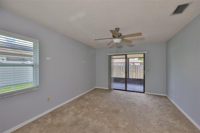 1717 Atrium Dr, Sun City Center, FL 33573 - carpeted spare room featuring a ceiling fan and a textured ceiling