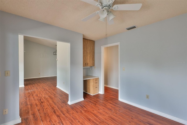 1717 Atrium Dr, Sun City Center, FL 33573 - unfurnished room with a ceiling fan, wood finished floors, and a textured ceiling