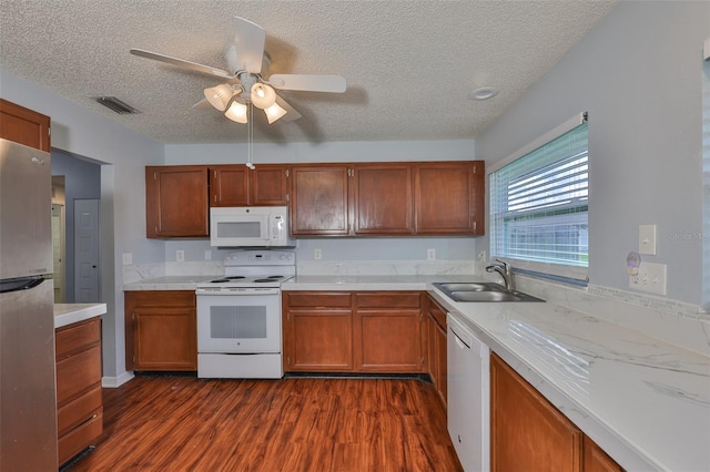 1717 Atrium Dr, Sun City Center, FL 33573 - kitchen featuring white appliances, dark wood-style floors, a textured ceiling, light countertops, and ceiling fan