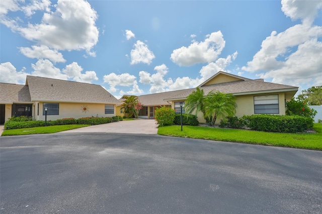 1717 Atrium Dr, Sun City Center, FL 33573 - view of front of home featuring driveway and a front lawn