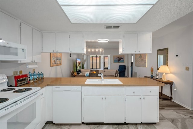 7433 Greystone Dr Unit 7433, Hudson, FL 34667 - kitchen with white appliances, a peninsula, and white cabinets