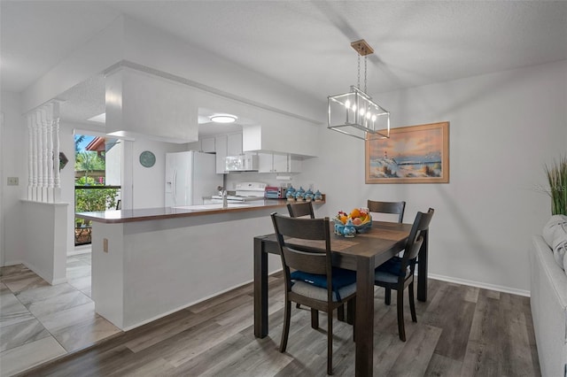 7433 Greystone Dr Unit 7433, Hudson, FL 34667 - dining space with baseboards and light wood finished floors