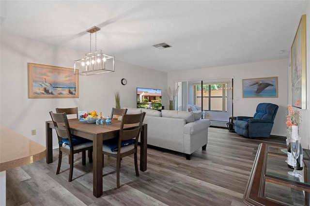 7433 Greystone Dr Unit 7433, Hudson, FL 34667 - dining space featuring wood finished floors and a chandelier
