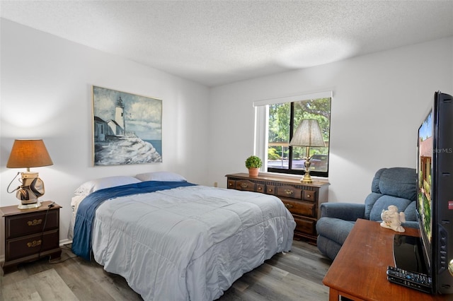 7433 Greystone Dr Unit 7433, Hudson, FL 34667 - bedroom featuring wood finished floors and a textured ceiling