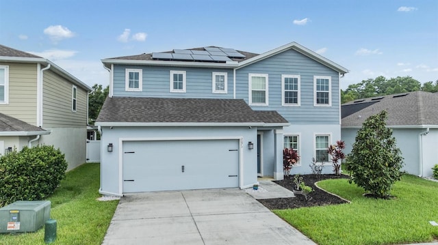 2073 Branding Iron Way, New Port Richey, FL 34655 - view of front of house featuring a front lawn, roof mounted solar panels, concrete driveway, a garage, and roof with shingles