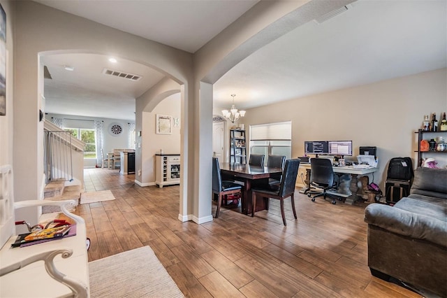 2073 Branding Iron Way, New Port Richey, FL 34655 - home office featuring arched walkways, a chandelier, wood finished floors, and beverage cooler