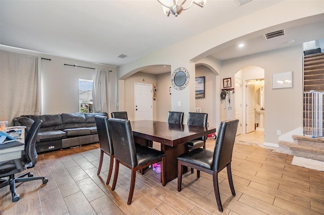 2073 Branding Iron Way, New Port Richey, FL 34655 - dining area featuring light wood-style flooring, arched walkways, stairway, and recessed lighting