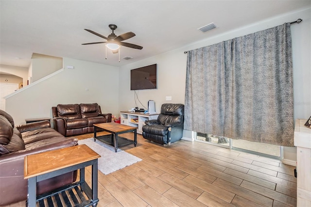 2073 Branding Iron Way, New Port Richey, FL 34655 - living area with ceiling fan, light wood-style flooring, and arched walkways