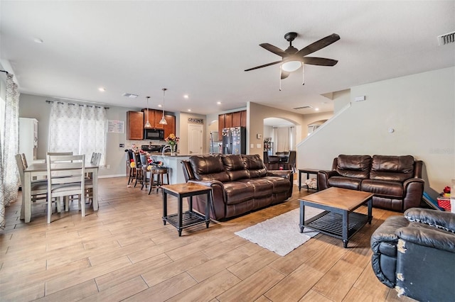 2073 Branding Iron Way, New Port Richey, FL 34655 - living area featuring a ceiling fan, arched walkways, light wood finished floors, and recessed lighting