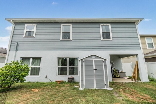 2073 Branding Iron Way, New Port Richey, FL 34655 - rear view of property featuring a shed and stucco siding