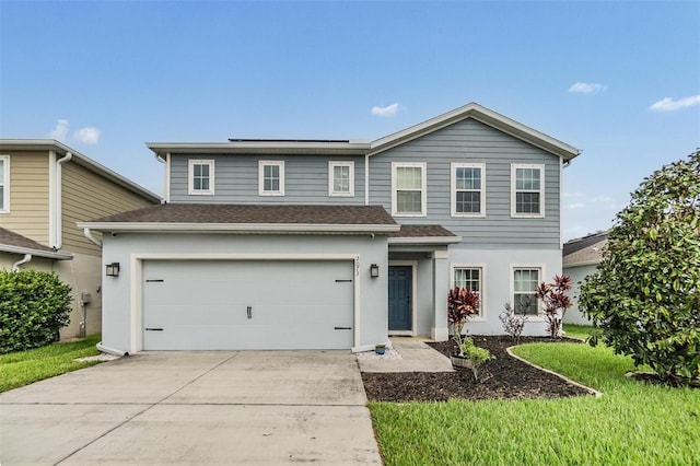 2073 Branding Iron Way, New Port Richey, FL 34655 - view of front of house featuring an attached garage, a shingled roof, concrete driveway, and stucco siding