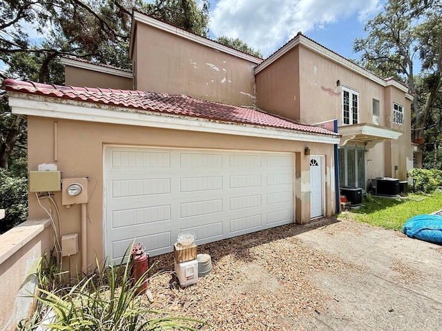16006 Armistead Ln, Odessa, FL 33556 - view of front of home with a tile roof, stucco siding, driveway, and a garage