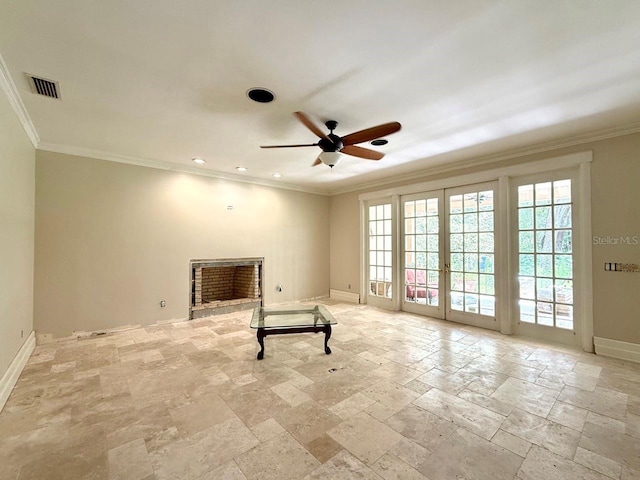 16006 Armistead Ln, Odessa, FL 33556 - spare room featuring a brick fireplace, ornamental molding, stone tile flooring, ceiling fan, and french doors